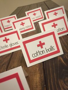 some red and white cards on top of a wooden table next to each other with the words cotton balls written across them