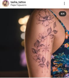 a woman's arm with flowers on it and the words tatsha tattoo