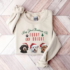 a sweater with two dogs wearing santa hats on the front, and merry christmas message on the back