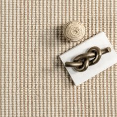 a pair of metal handles sitting on top of a white piece of paper next to a knot