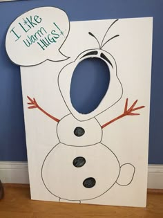 a cardboard snowman with a thought bubble saying i like you more