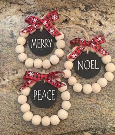 three christmas wreaths with words on them