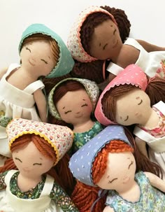 a pile of cloth dolls sitting next to each other