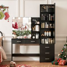 a christmas tree is in the corner of a room next to a desk and shelves