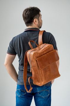 ● Large leather cognac backpack with big inside and outside pockets ● ● Large backpack is made by hand from genuine leather. Has three inner pockets and one large outer pocket with a flap. This backpack is suitable for both men and women. It can be used in everyday life for work, study, sports and travel. The backpack is made of high-quality genuine leather that guarantees its durable use.● ● Easily fits a 15.6 '' laptop in this backpack ● ● Unique leather over time gets better. A bag can be mad Leather Backpack With Luggage Sleeve, Large Capacity Leather Backpack, Cognac Backpack With Leather Backing For Travel, Functional Brown Leather Backpack, Brown Leather Backpack Functional Style, Cognac Leather Travel Backpack, Everyday Carry Backpack With Luggage Sleeve, Leather School Backpack With Luggage Sleeve, Brown Leather Functional Backpack