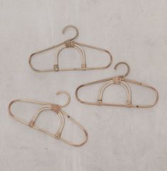 three pairs of clothes hangers on a white background