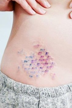 a woman's stomach with an abstract pattern on the side and her lower back