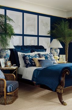 an image of a bedroom setting with blue and white decor on the walls, palm trees in the window