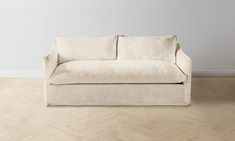 a white couch sitting on top of a hard wood floor