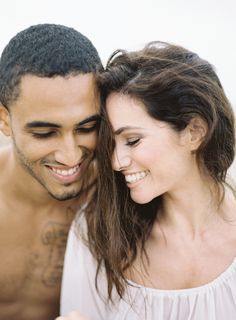 a man and woman smiling at each other