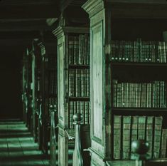 an old library with bookshelves and chairs in black and white photo taken from the floor