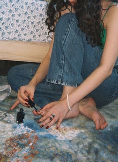 a woman is sitting on the floor with her hands together