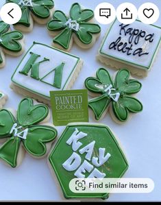 decorated cookies with green and white icing are arranged in the shape of clovers