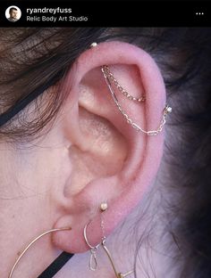 a close up of a person's ear with three different types of piercings