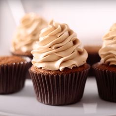 cupcakes with frosting sitting on a white plate