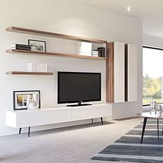 a living room with white walls and wooden shelves on the wall, along with a large flat screen tv