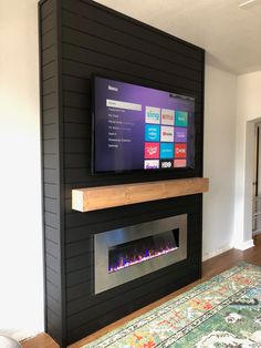 a flat screen tv mounted on the wall above a fireplace