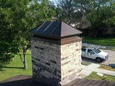 a white truck parked next to a brick chimney