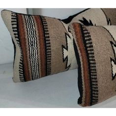 two brown and black striped pillows sitting next to each other