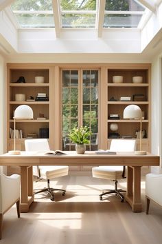 an office with two white chairs and a wooden desk in front of a large window