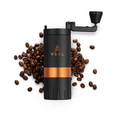 a coffee grinder surrounded by coffee beans on a white background with the word vssl written in gold