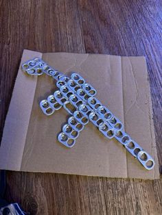 a metal cross sitting on top of a piece of paper next to a pair of scissors