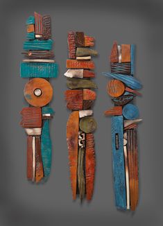 three pieces of art made out of wood with different colors and shapes on the sides