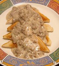 a white plate topped with french fries covered in gravy