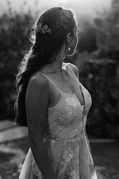 black and white photograph of a woman in a wedding dress looking off into the distance