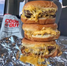 three cheeseburgers stacked on top of each other