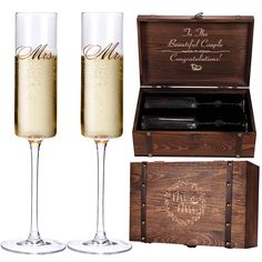 two champagne flutes in front of a wooden box with the words mr and mrs engraved on it