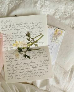 someone is holding an old letter with flowers on it