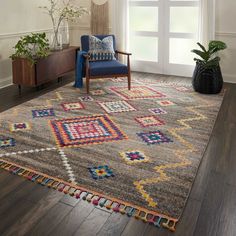 a living room area with a chair, rug and potted plant on the floor