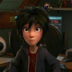 an animated character sitting at a desk with a computer in front of him and looking into the distance