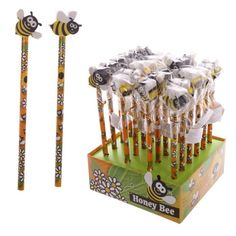 a bunch of bees are in a box with some pens and pencils next to it