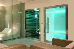 a bathroom with a purple light in the shower and bathtub next to each other