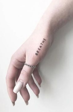 a person's hand with a small tattoo that says, i just want to find my place in all of this