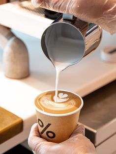 a person pouring coffee into a cup