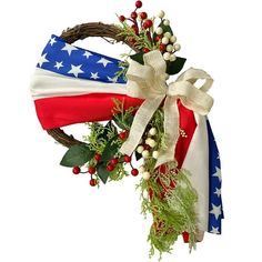 an american flag wreath with berries and greenery