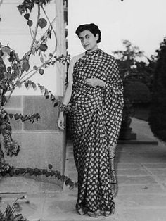 an old black and white photo of a woman in a sari