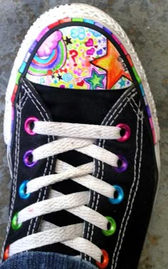 someone's shoes are decorated with colorful designs