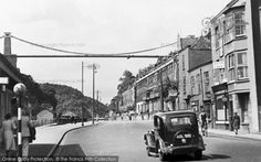 an old car is driving down the street