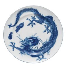 a blue and white plate with a dragon on it