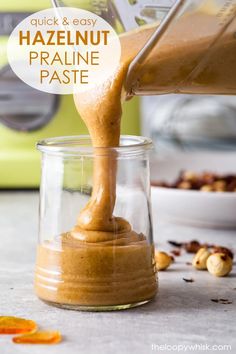 peanut butter being poured into a glass jar