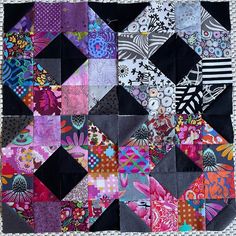 a patchwork quilt with many different designs on it