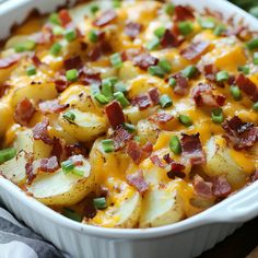 a casserole dish with potatoes, bacon and green onions