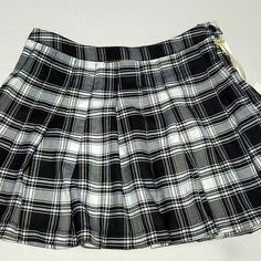 Black And White Plaid Pleated Mini Skirt. Button And Side Zipper. 100% Polyester. This Skirt Is Marked Size L, But It Runs Small. Please Refer To Measurement Before Buying. 30" Waist, 38" Hips, 16" L. Academia, Spirit, Festival, Preppy Black Preppy Pleated Skort, Black Pleated Preppy Skort, Preppy Black Skort For School, Preppy Black Pleated Tennis Skirt, Preppy Black Tennis Skirt For School, Black Fitted Mini Skirt In Preppy Style, Black Fitted Mini Skirt Preppy Style, Fitted Black Mini Skirt In Preppy Style, Black Fitted Preppy Mini Skirt