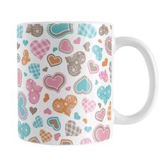 a white coffee mug with hearts on it