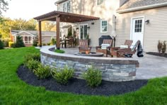 an outdoor patio with chairs and fire pit