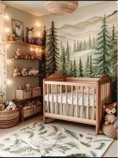 a baby's room with a forest mural on the wall